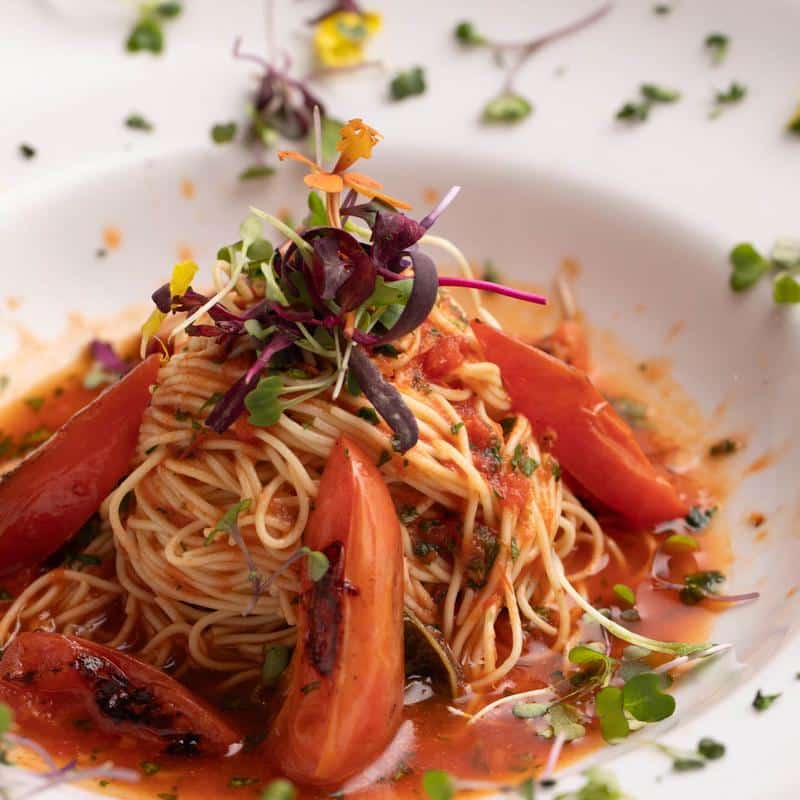Grilled octopus with purple noodles and flowers