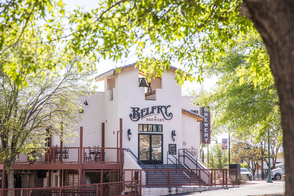 Belfry Smoked Grill Brewery exterior with outdoor seating and stairs on sunny day