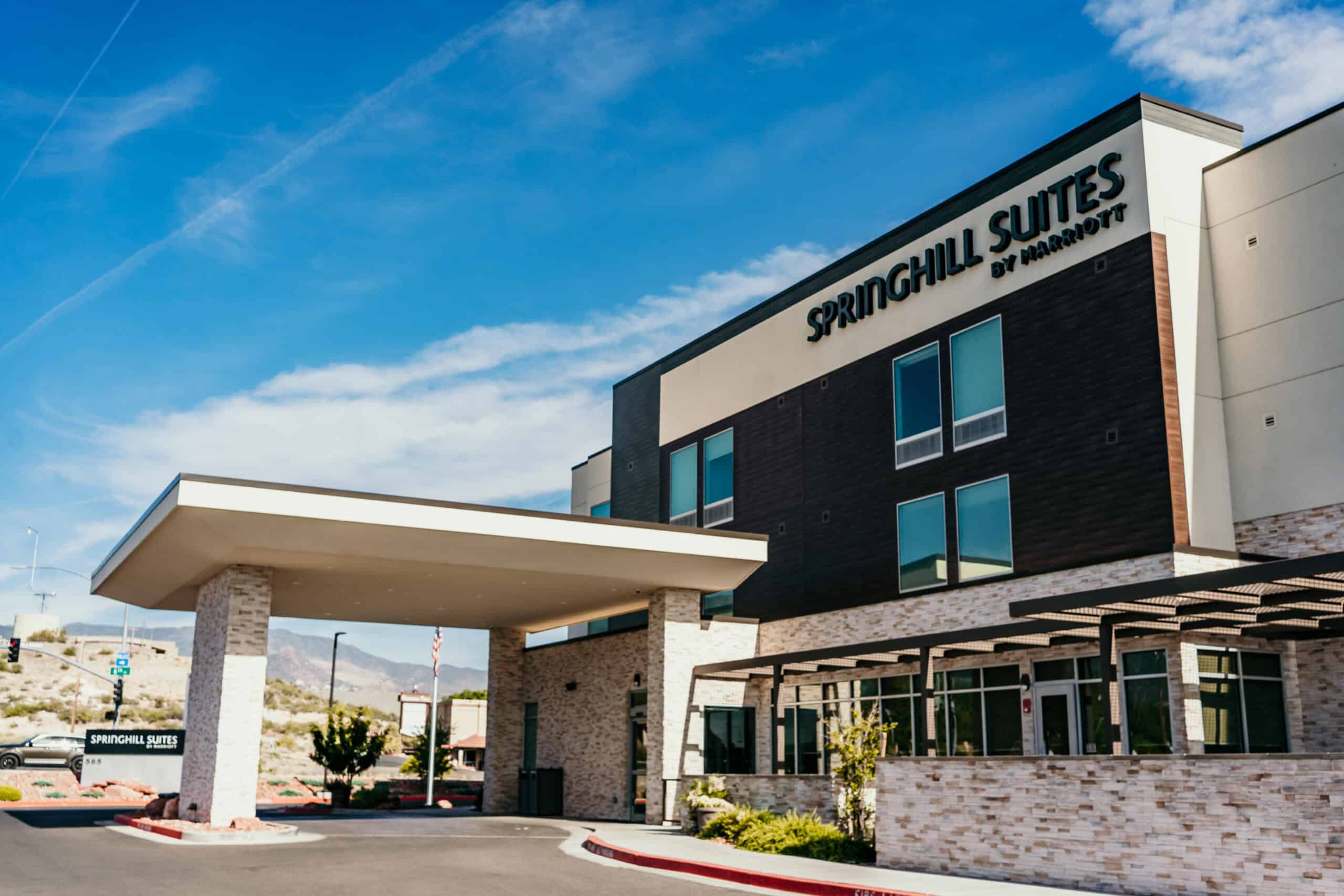 SpringHill Suites by Marriott modern hotel with covered entrance and clear blue sky