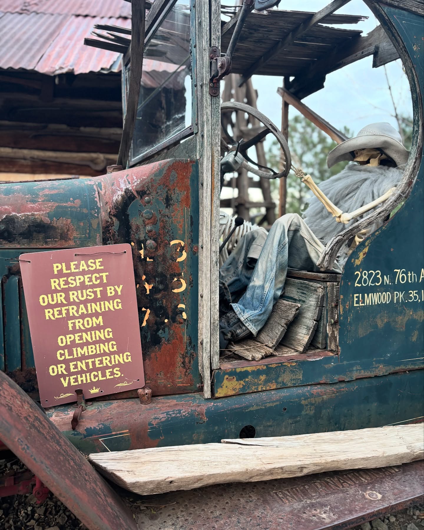 Vintage tractor display with rust preservation notice and mannequin driver.