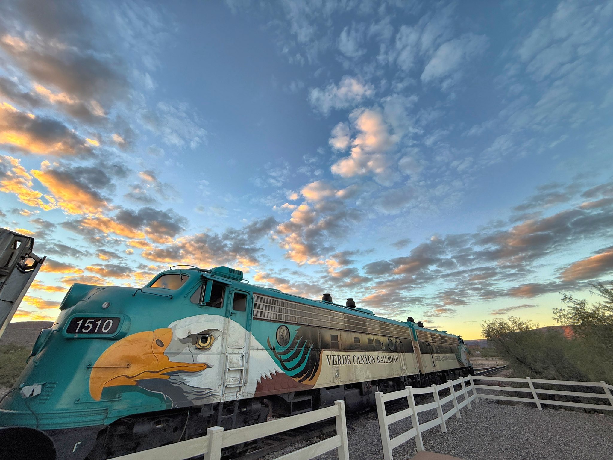 Historic Verde Canyon Railroad train with eagle design at sunset