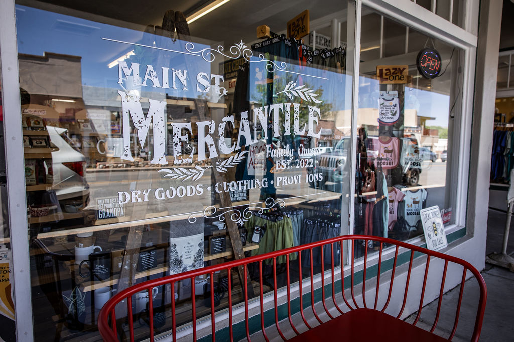 Main Street Mercantile shop window displaying dry goods, clothing, and provisions since 1972.