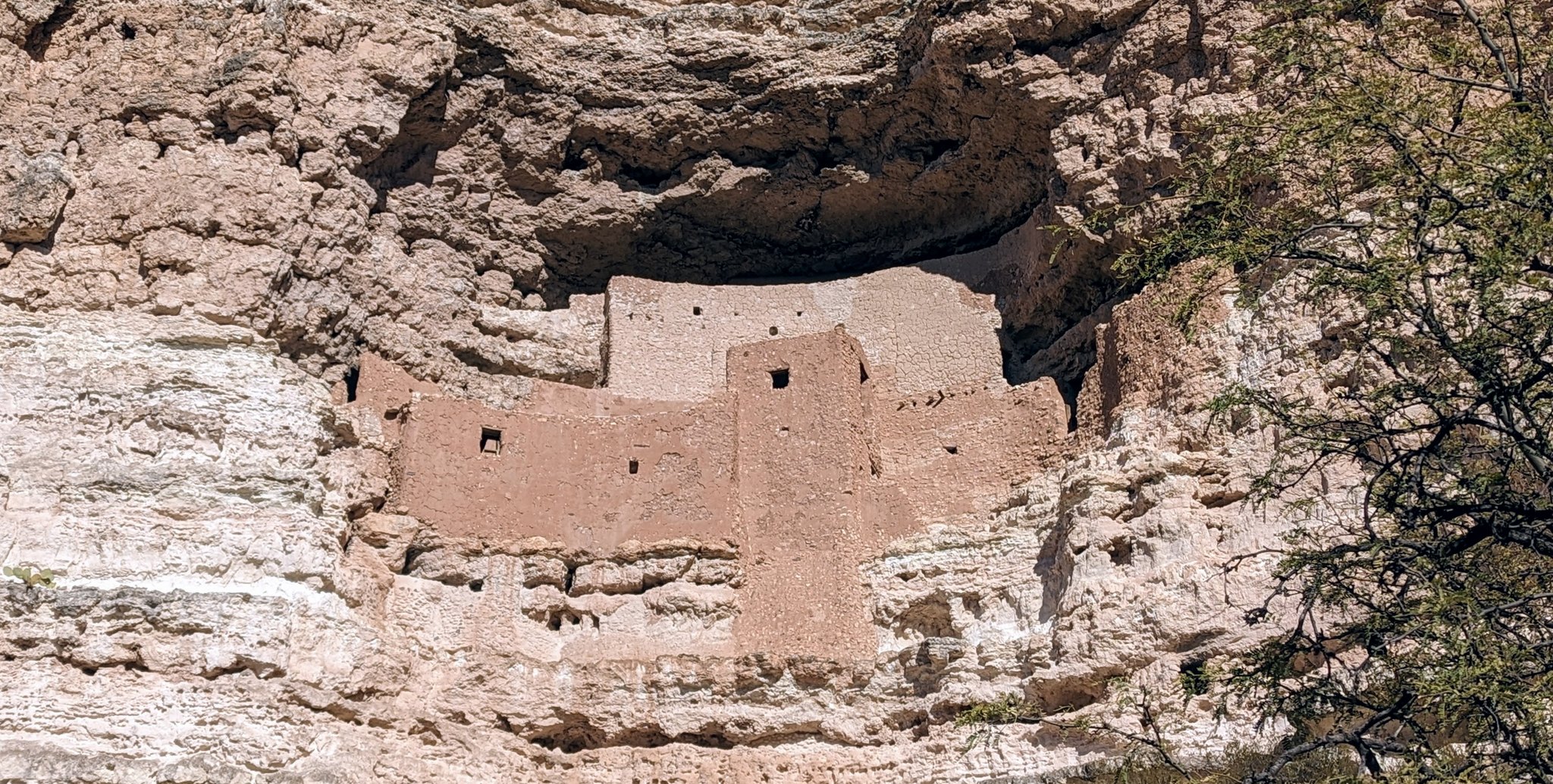 Ancient cliff dwelling ruins in rocky terrain