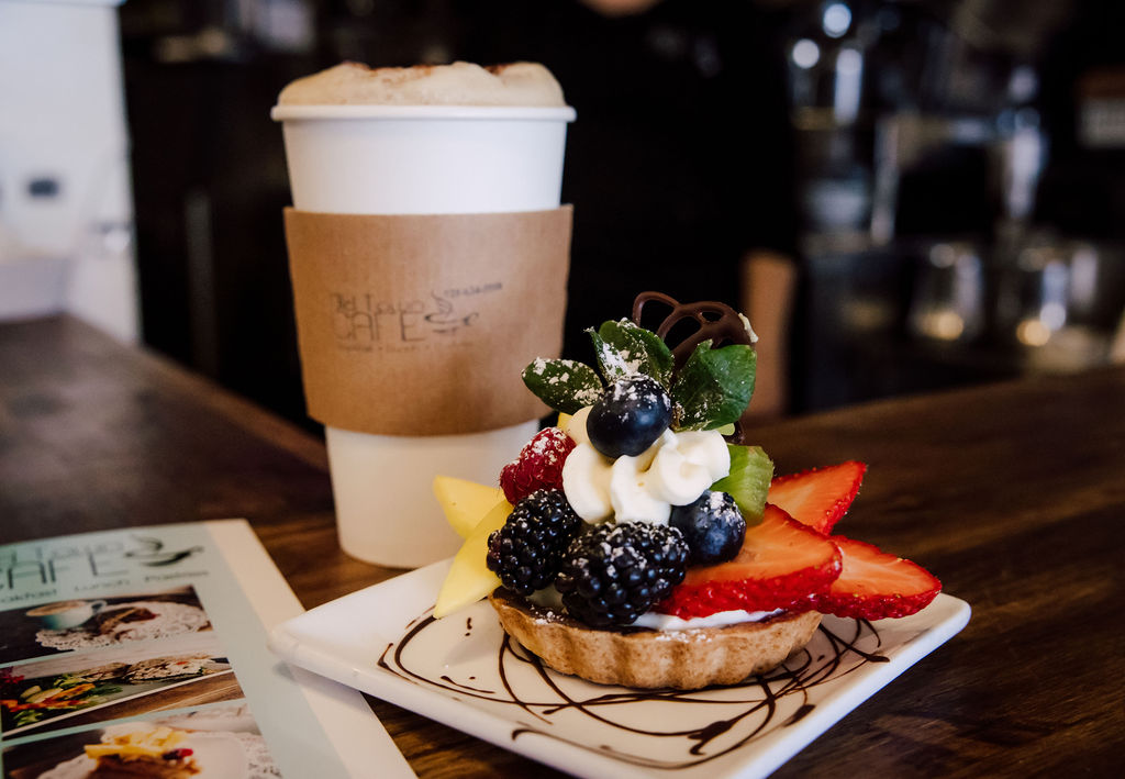 Wedding cake and gifts on wooden table