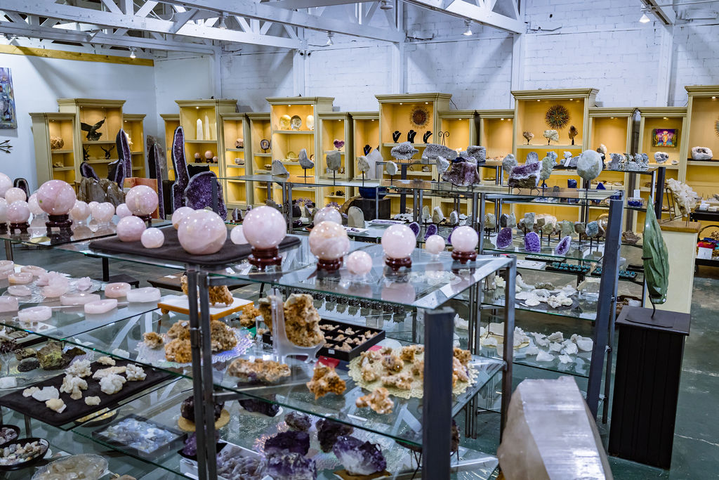 Crystal shop displaying various gemstones, minerals, and geodes for sale
