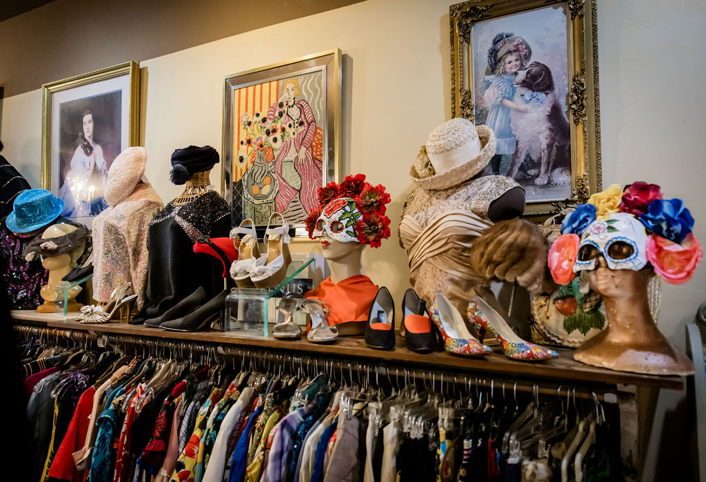 Vintage costumes, hats, and accessories on display in boutique store.