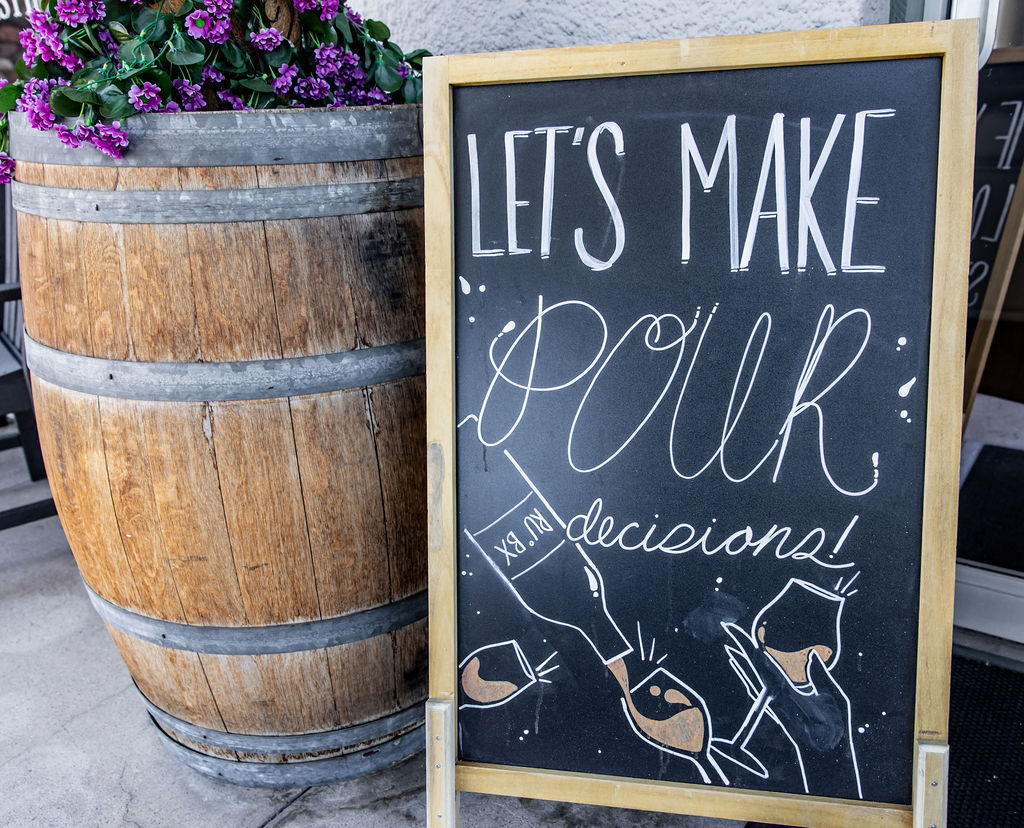 Chalkboard sign promoting pull decisions with playful pig illustration.