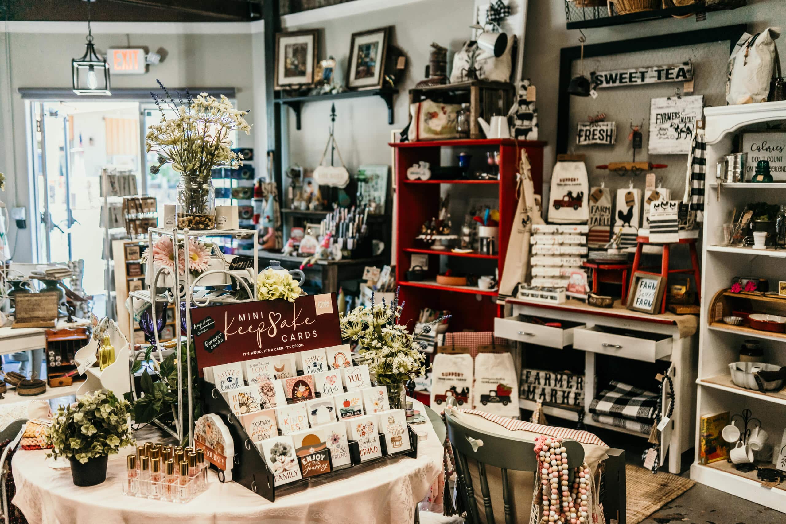 Rustic shop displaying handmade cards, decor, and farm-themed merchandise.