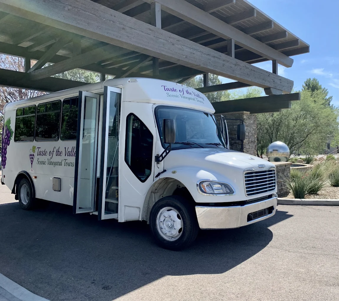 White Taste of the Valley tour bus for scenic vineyard tours parked under shelter.