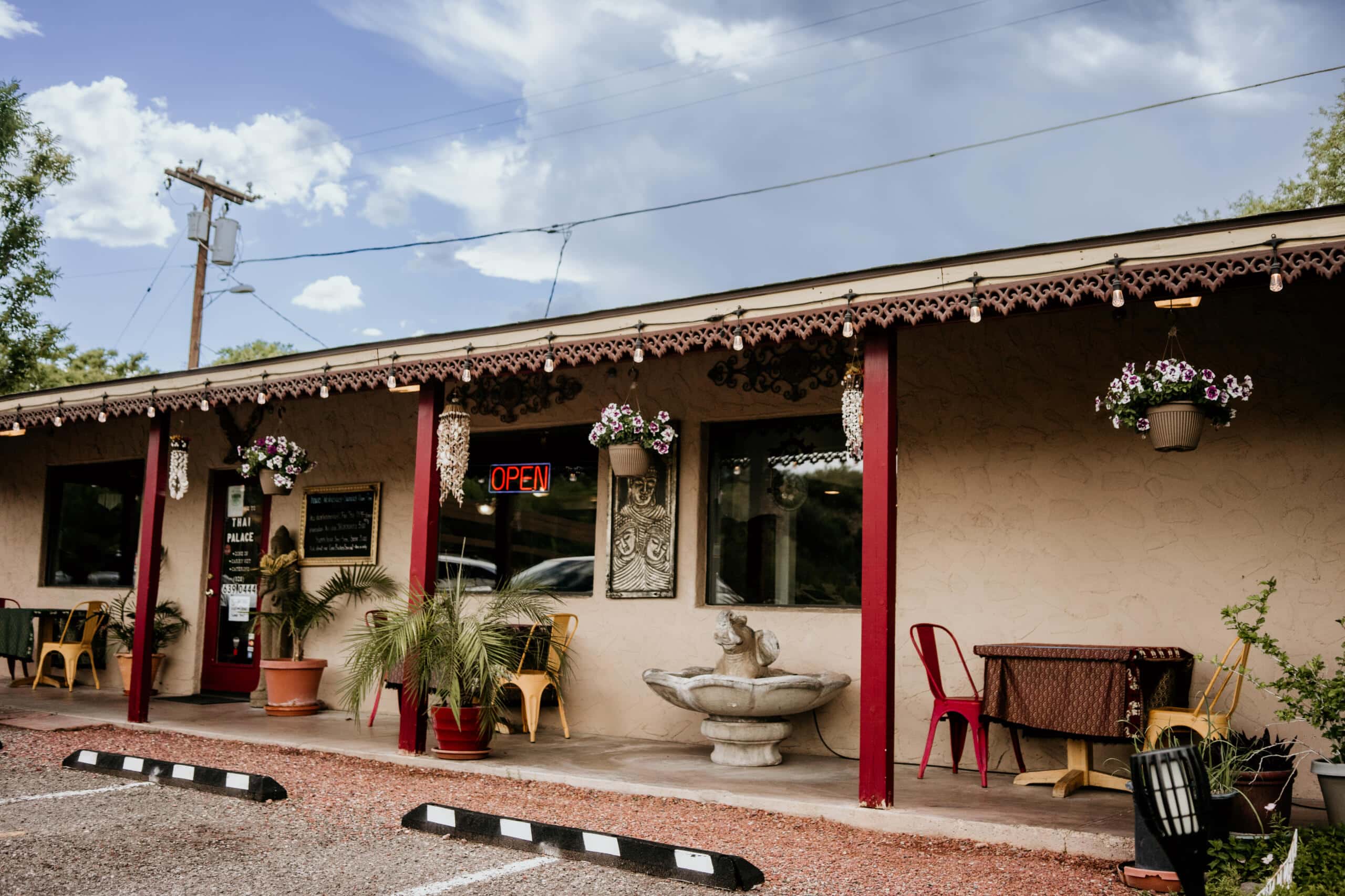 Charming Thai restaurant patio with outdoor seating and potted plants