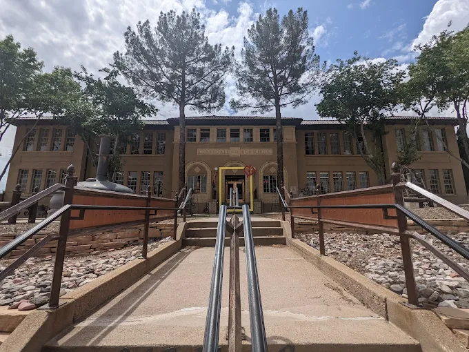 Entrance to Colorado School for the Deaf and Blind building with stairs and railings.