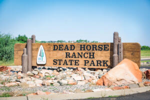 Dead Horse Ranch State Park wooden entrance sign with rocky base