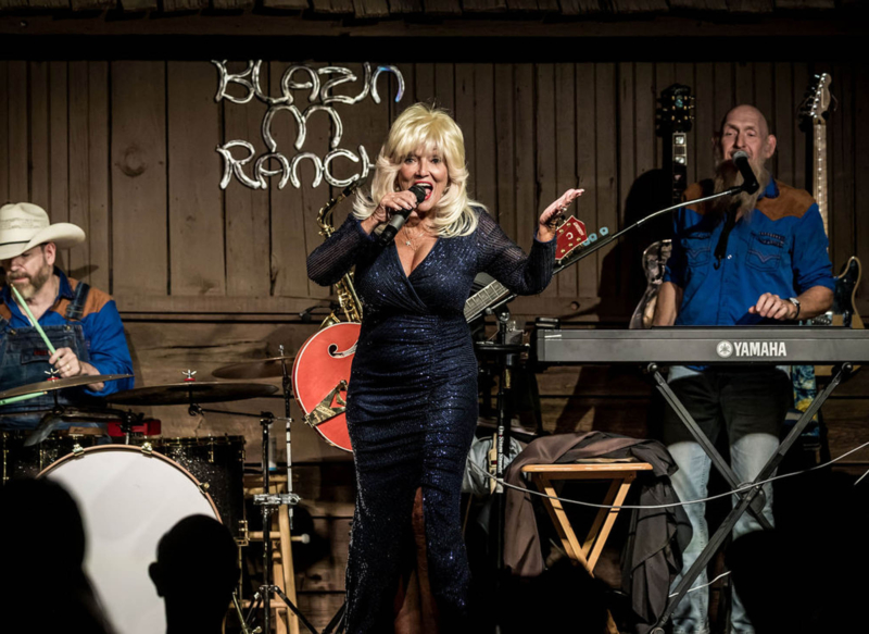 Live country music band performing on stage at Blue Suede Ranch.
