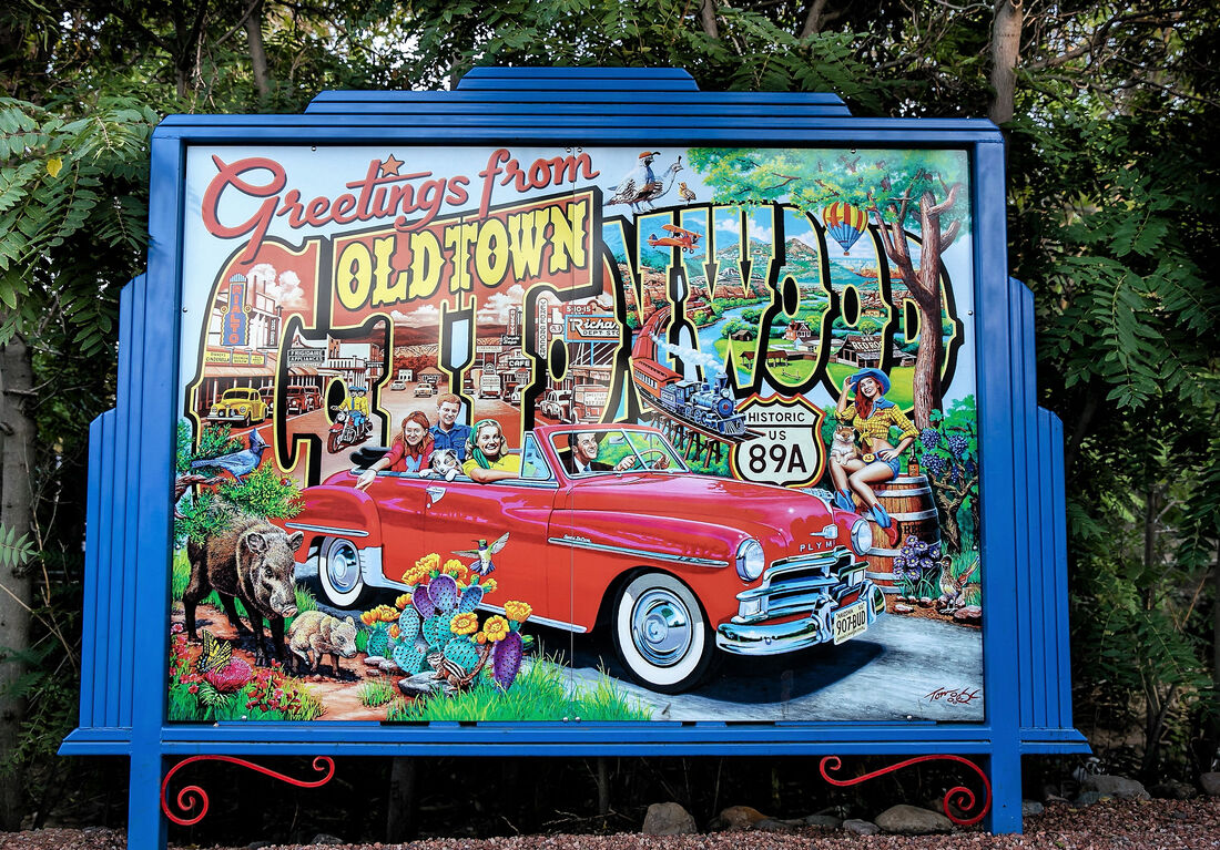 Vintage welcome sign for Old Town Tucson, Arizona, featuring retro car and scenic desert imagery.