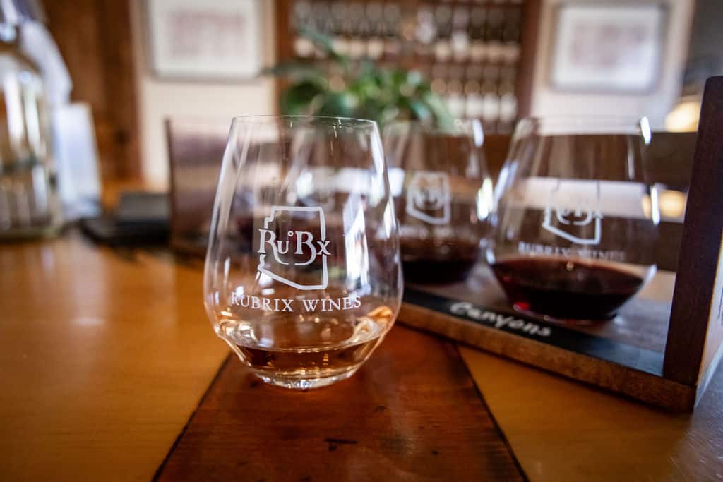 Wine glass with RuBrix label on wooden counter