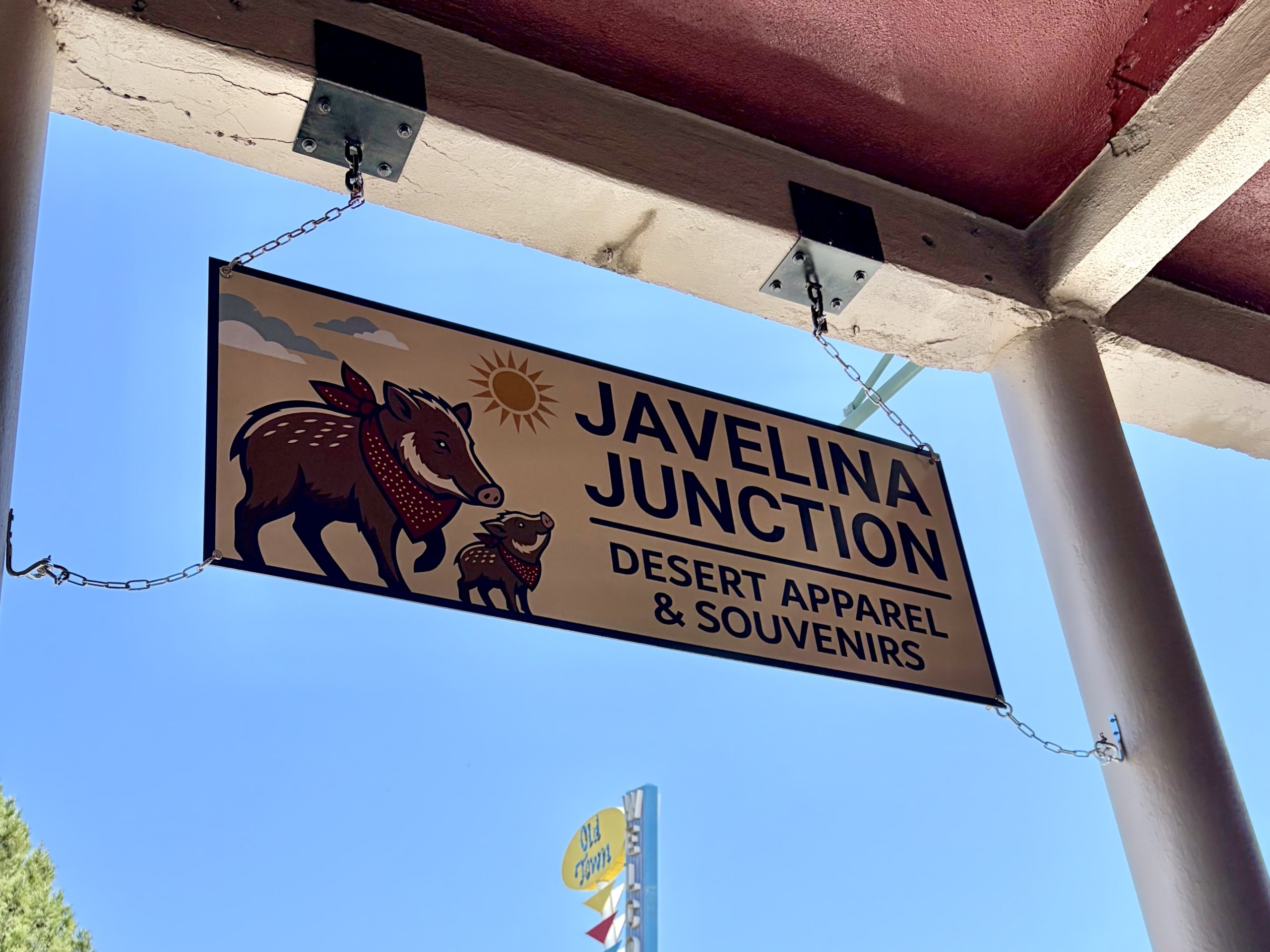 Javelina Junction Javelina Desert Taphouse sign hanging beneath wooden beams