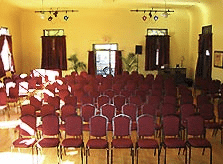 Rows of red chairs in a bright meeting hall